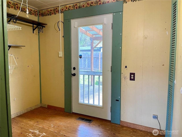 doorway with visible vents and wood-type flooring