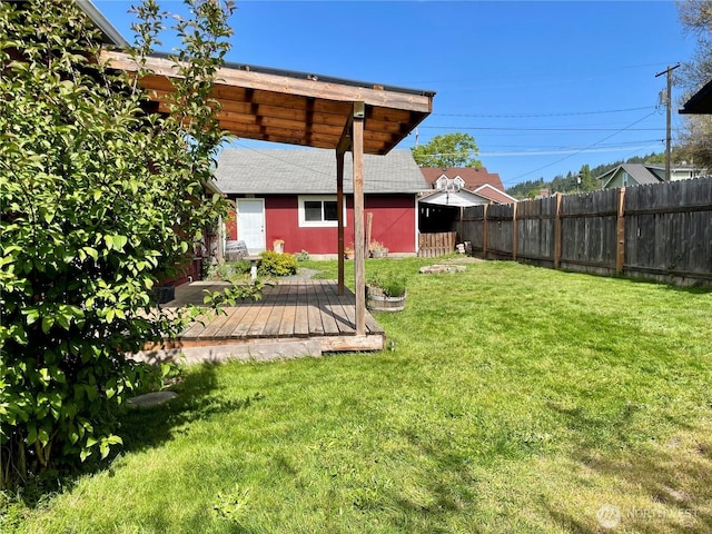 view of yard with fence private yard and a wooden deck