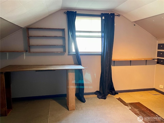 bonus room featuring baseboards and vaulted ceiling