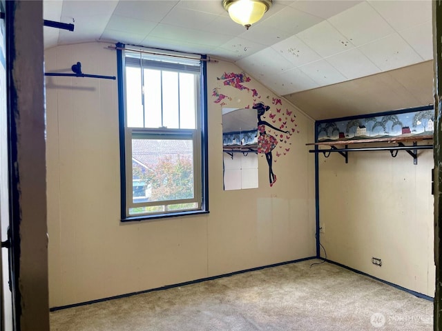 bonus room featuring vaulted ceiling and carpet flooring