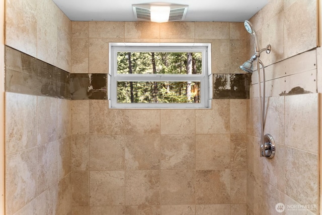 bathroom featuring visible vents and tiled shower