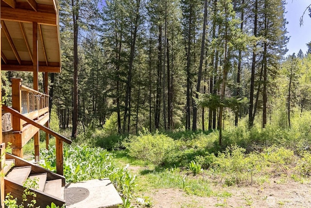 view of yard featuring stairway and a forest view
