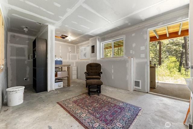 living area with visible vents and concrete flooring