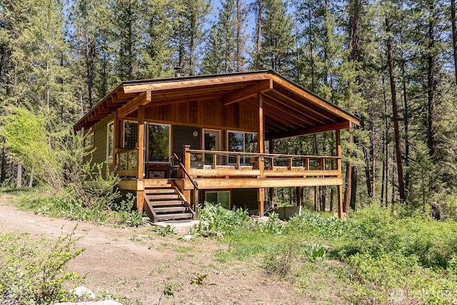 view of outdoor structure with stairway and a forest view