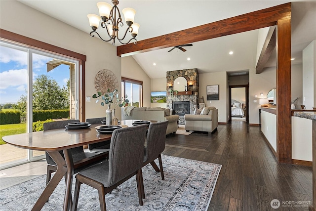 dining area with a fireplace, ceiling fan with notable chandelier, baseboards, wood finished floors, and vaulted ceiling with beams