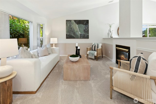 18711 22nd Dr SE, Bothell, WA 98012 - carpeted living room with plenty of natural light, lofted ceiling, a glass covered fireplace, and baseboards