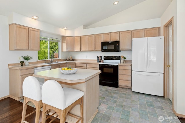 18711 22nd Dr SE, Bothell, WA 98012 - kitchen with freestanding refrigerator, black microwave, range with electric stovetop, light brown cabinets, and lofted ceiling