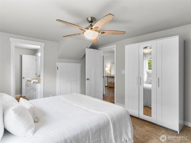 bedroom with carpet, baseboards, ceiling fan, and connected bathroom