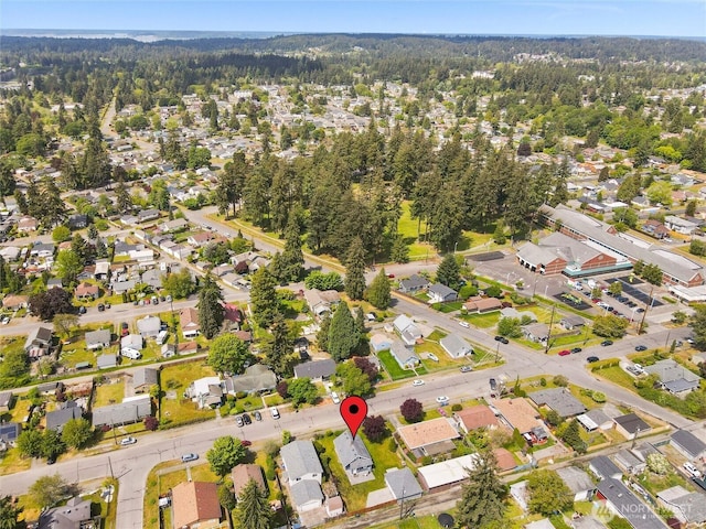 aerial view of property and surrounding area with nearby suburban area
