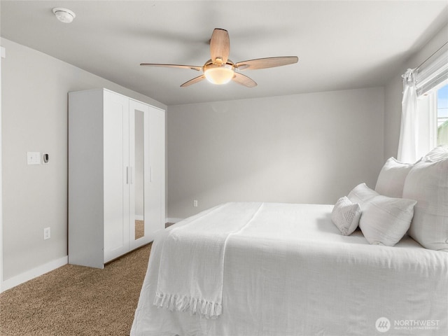 bedroom featuring carpet floors, ceiling fan, and baseboards