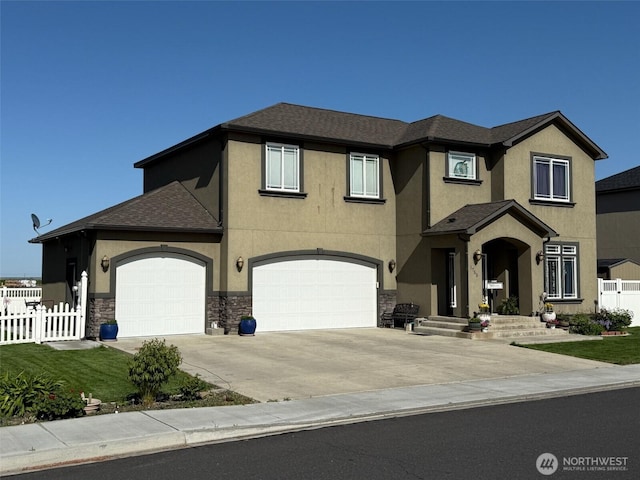 1755 E Madera St, Othello, WA 99344 - view of front of home with fence, a shingled roof, stone siding, stucco siding, and driveway