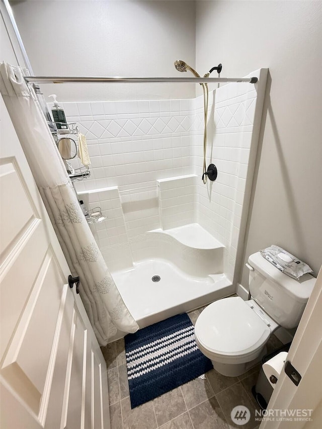 1755 E Madera St, Othello, WA 99344 - bathroom with tile patterned flooring, a stall shower, and toilet