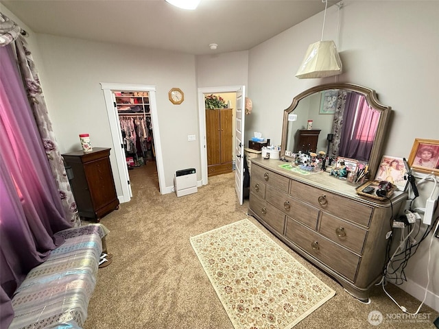 1755 E Madera St, Othello, WA 99344 - bedroom featuring baseboards, light carpet, a walk in closet, and a closet