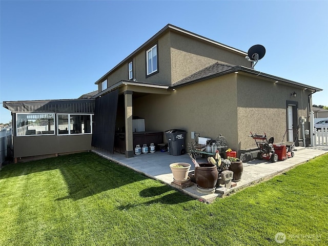 1755 E Madera St, Othello, WA 99344 - back of property with a patio, a lawn, and stucco siding