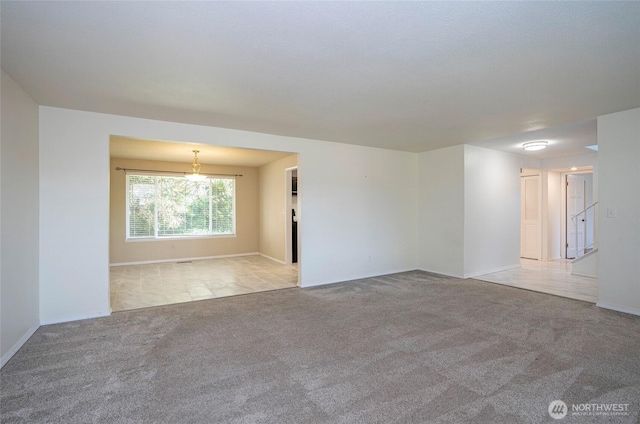 empty room with light carpet and baseboards