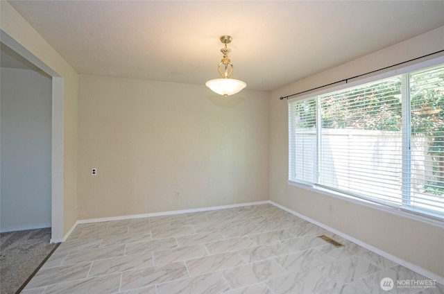 empty room with baseboards