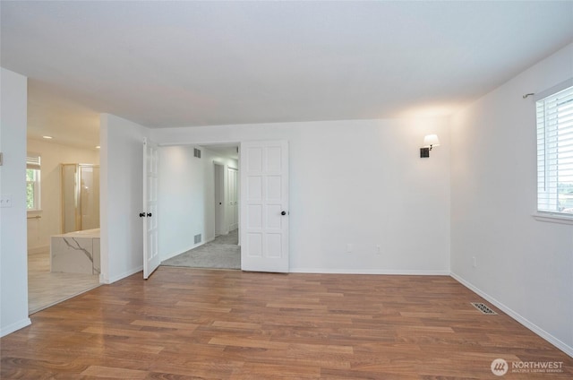 unfurnished room featuring wood finished floors and baseboards