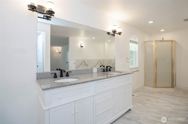 full bathroom featuring a stall shower, double vanity, marble look tiles, and recessed lighting