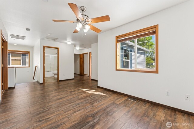 unfurnished room featuring dark wood-style flooring, baseboards, and ceiling fan