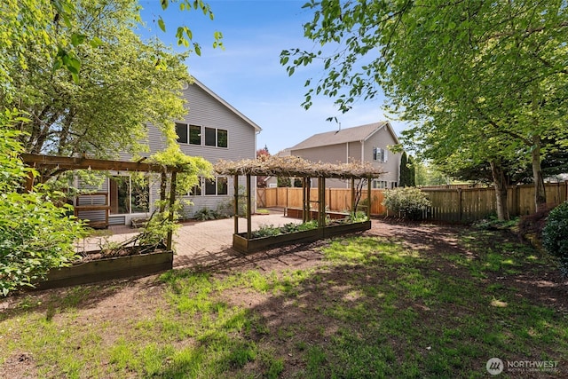 back of property with a vegetable garden and a pergola