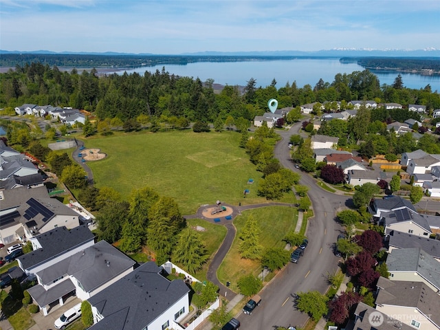 aerial view of residential area featuring a nearby body of water