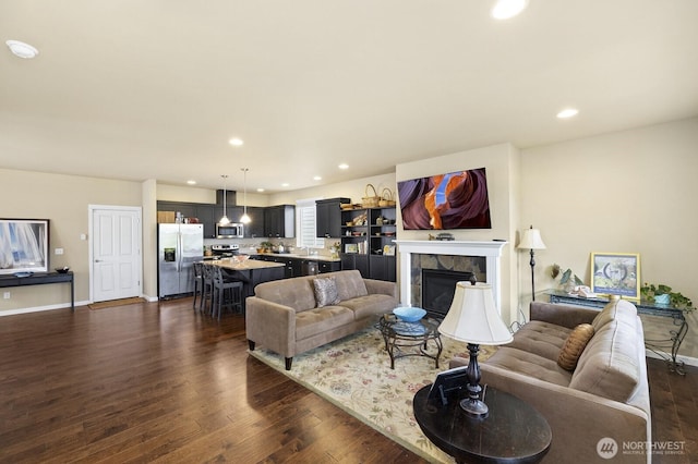 18709 138th Street Ct E, Bonney Lake, WA 98391 - living area featuring recessed lighting, dark wood-type flooring, a fireplace, and baseboards
