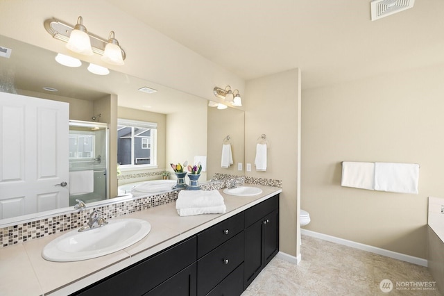 18709 138th Street Ct E, Bonney Lake, WA 98391 - bathroom with double vanity, baseboards, and toilet