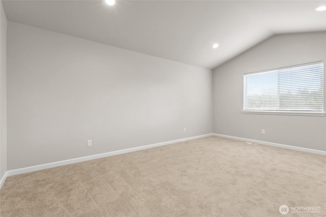 spare room with baseboards, light carpet, recessed lighting, and lofted ceiling