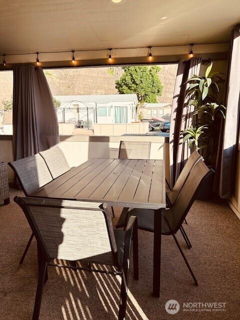 view of patio featuring outdoor dining area and a balcony