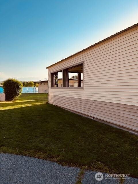 view of side of home featuring a yard