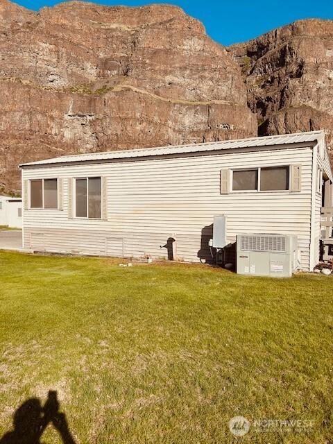 exterior space with a lawn and a mountain view