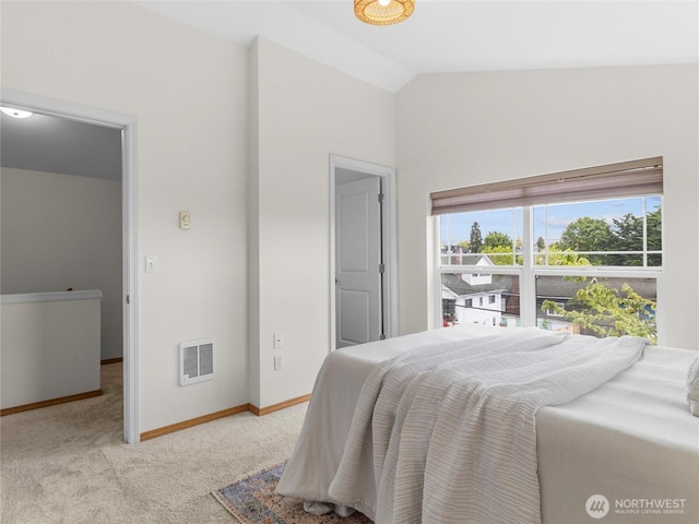 bedroom featuring carpet floors, vaulted ceiling, and baseboards