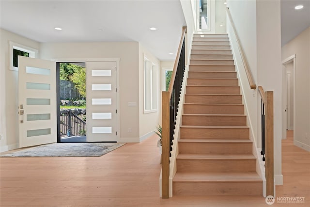 entrance foyer featuring recessed lighting, stairs, and wood finished floors