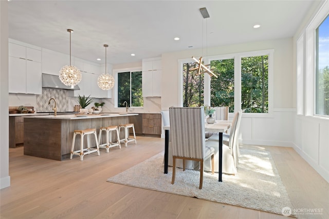 dining room featuring light wood-style floors, recessed lighting, and a wealth of natural light