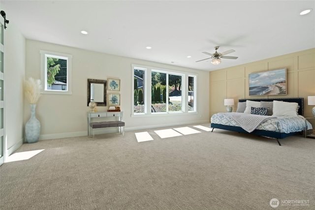 carpeted bedroom featuring a ceiling fan, recessed lighting, and multiple windows