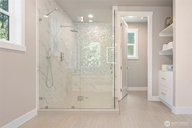 bathroom with baseboards, recessed lighting, a marble finish shower, and tile patterned floors