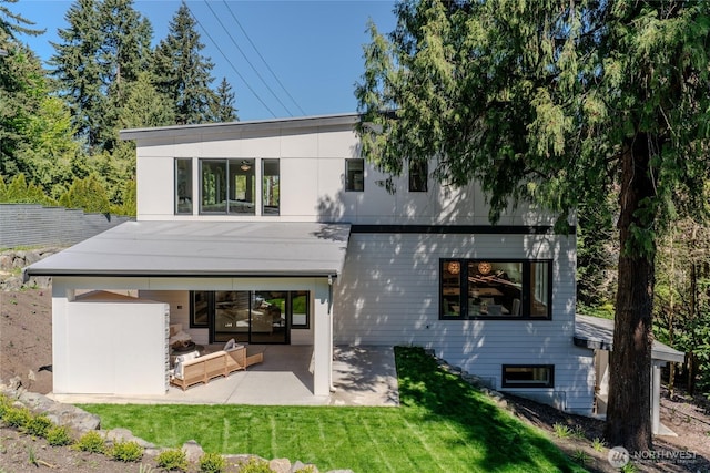 back of house with a lawn and a patio area