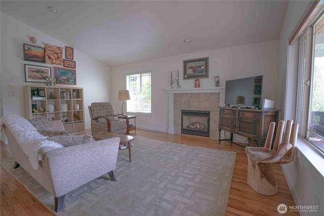 2078 11th St, Port Townsend, WA 98368 - living room featuring wood finished floors, vaulted ceiling, and a fireplace
