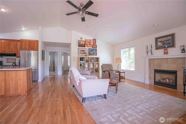 2078 11th St, Port Townsend, WA 98368 - living area with light wood-type flooring, vaulted ceiling, a ceiling fan, a fireplace, and recessed lighting