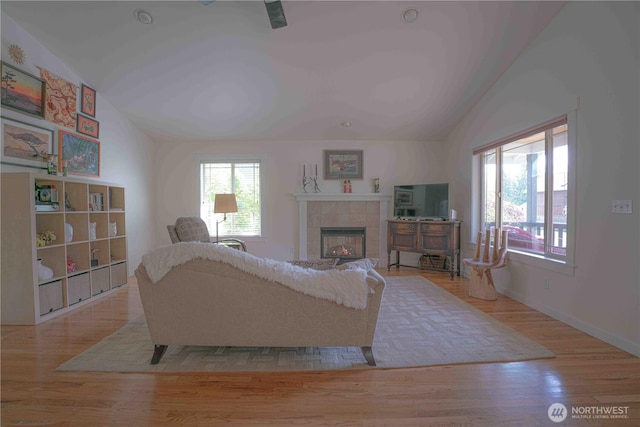 2078 11th St, Port Townsend, WA 98368 - living room with vaulted ceiling, a fireplace, wood finished floors, and baseboards