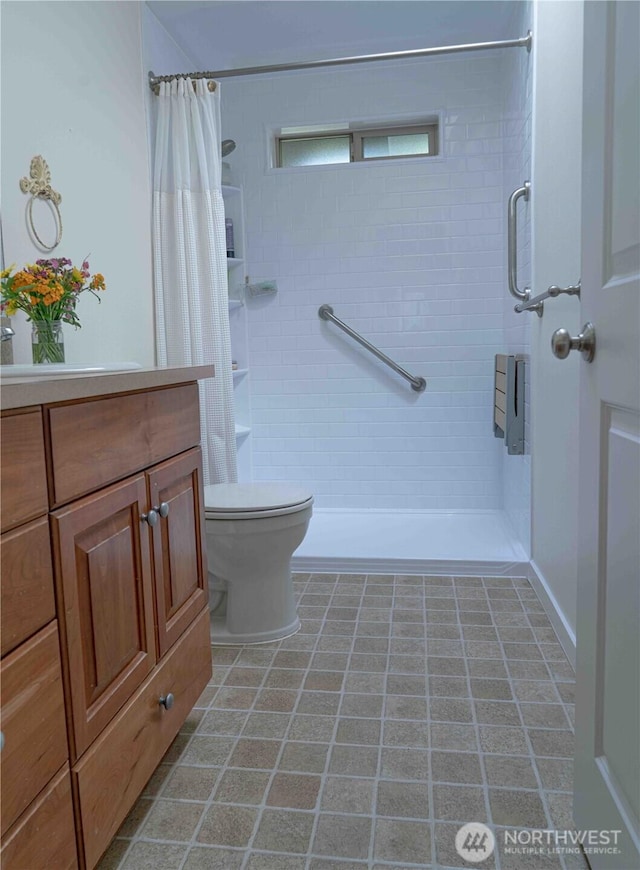 2078 11th St, Port Townsend, WA 98368 - full bath featuring tiled shower, toilet, vanity, and tile patterned floors