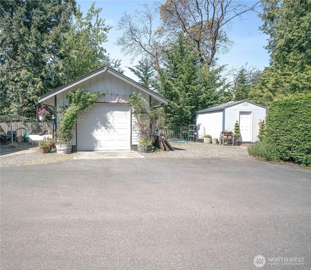 2078 11th St, Port Townsend, WA 98368 - view of front of house featuring an outbuilding, fence, a storage unit, and driveway