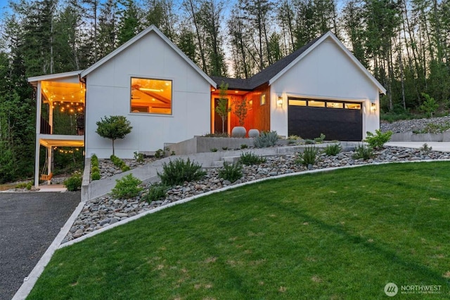 5601 Lewis River Rd, Ariel, WA 98603 - view of front facade featuring a front lawn, a garage, and driveway