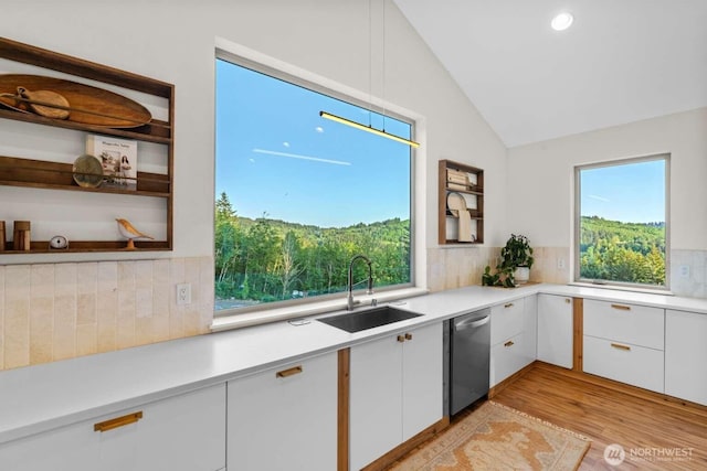 5601 Lewis River Rd, Ariel, WA 98603 - kitchen featuring dishwasher, a sink, decorative backsplash, light countertops, and lofted ceiling