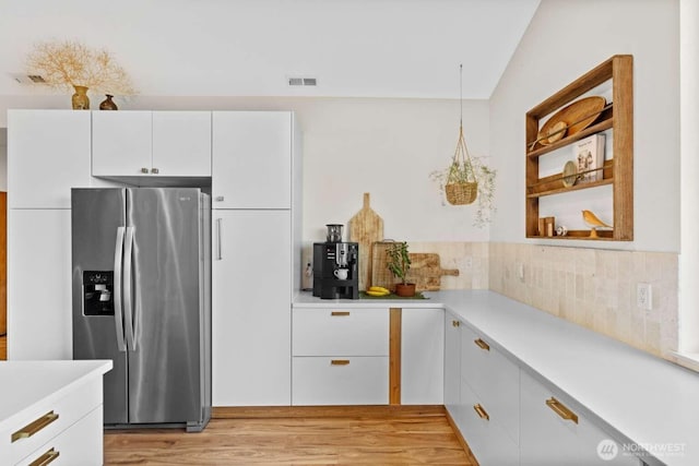 5601 Lewis River Rd, Ariel, WA 98603 - kitchen featuring stainless steel fridge with ice dispenser, light countertops, and white cabinetry