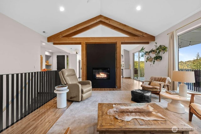 5601 Lewis River Rd, Ariel, WA 98603 - living area featuring wood finished floors, vaulted ceiling, a large fireplace, and recessed lighting