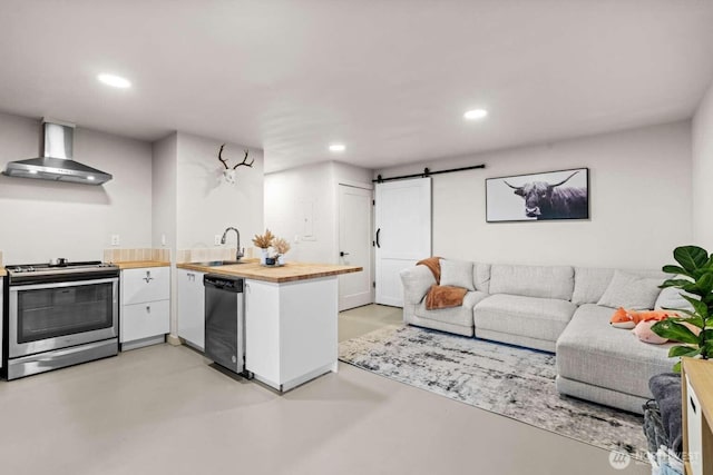5601 Lewis River Rd, Ariel, WA 98603 - kitchen with stainless steel electric stove, wall chimney range hood, wooden counters, a sink, and recessed lighting