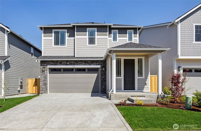 view of front of home featuring an attached garage, driveway, and stone siding