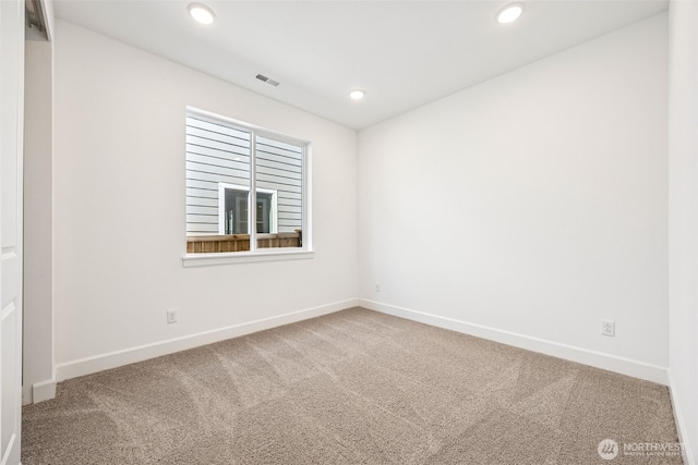 carpeted spare room with baseboards, recessed lighting, and visible vents