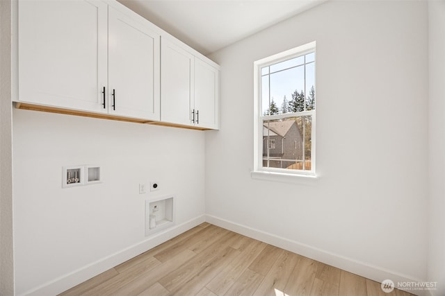 laundry room with washer hookup, electric dryer hookup, cabinet space, baseboards, and light wood finished floors